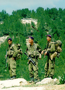 Photo: Three Israeli soldiers framed against the mountain