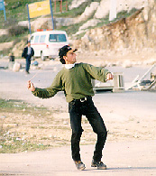 Photo: Demonstrator throwing stones