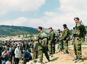 Photo: Israeli soldiers watch over demonstrators