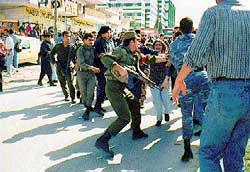 Photo: Palestinian Police get in between the two sides.