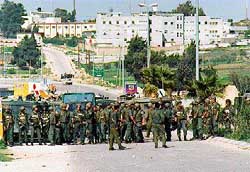 Photo: Israeli soldiers with Beit El and the IDF district headquarters in the background.