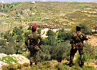 Photo: Palestinian Police watch the approaching marchers