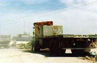 Photo: concrete blockes being moved into position by trucks