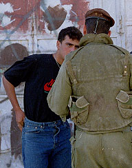 Photo: Palestinian teenager being asked for his identity card