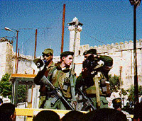 Photo: Israeli soldiers giving orders through a megaphone and videoing the crowd