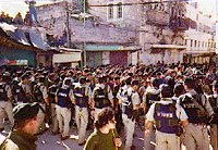 Photo: Row of soliders push back those present