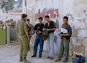 Photo: Palestinian youths being searched outside CPT offices