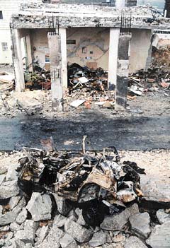 Photo: The wreckage after the bombing, from the Jerusalem Post. 
Click for the JP article.