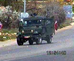 Photo: Israeli jeep arrives. Palestinian women in the background look on unsurprised.
