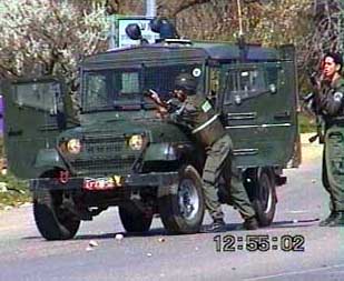 Photo: Israeli jeep having arrived, they're out and shooting into a gas station.