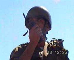 Photo: Israeli soldier radios Palestinian liaison officer to request intervention.