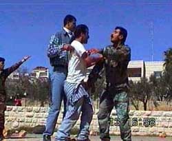 Photo: Palestinian police push back a protester.